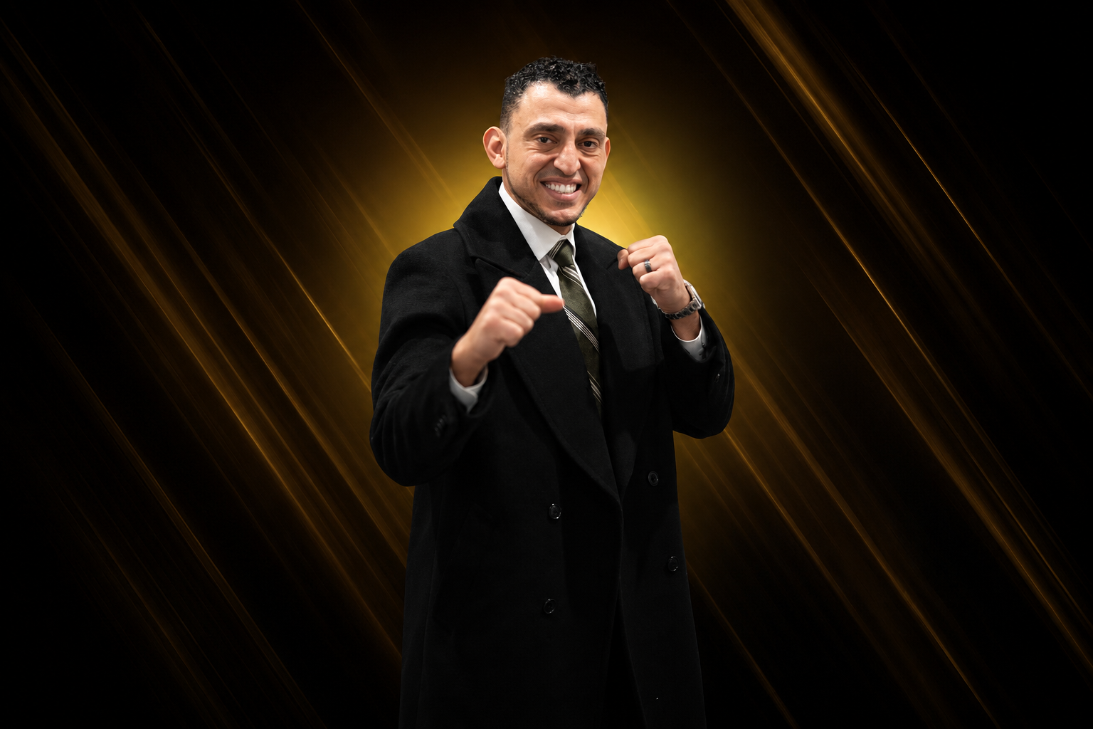 Ibrahim J. Awad in a long black overcoat, fists raised in a fighting guard, against a gold-streaked backdrop