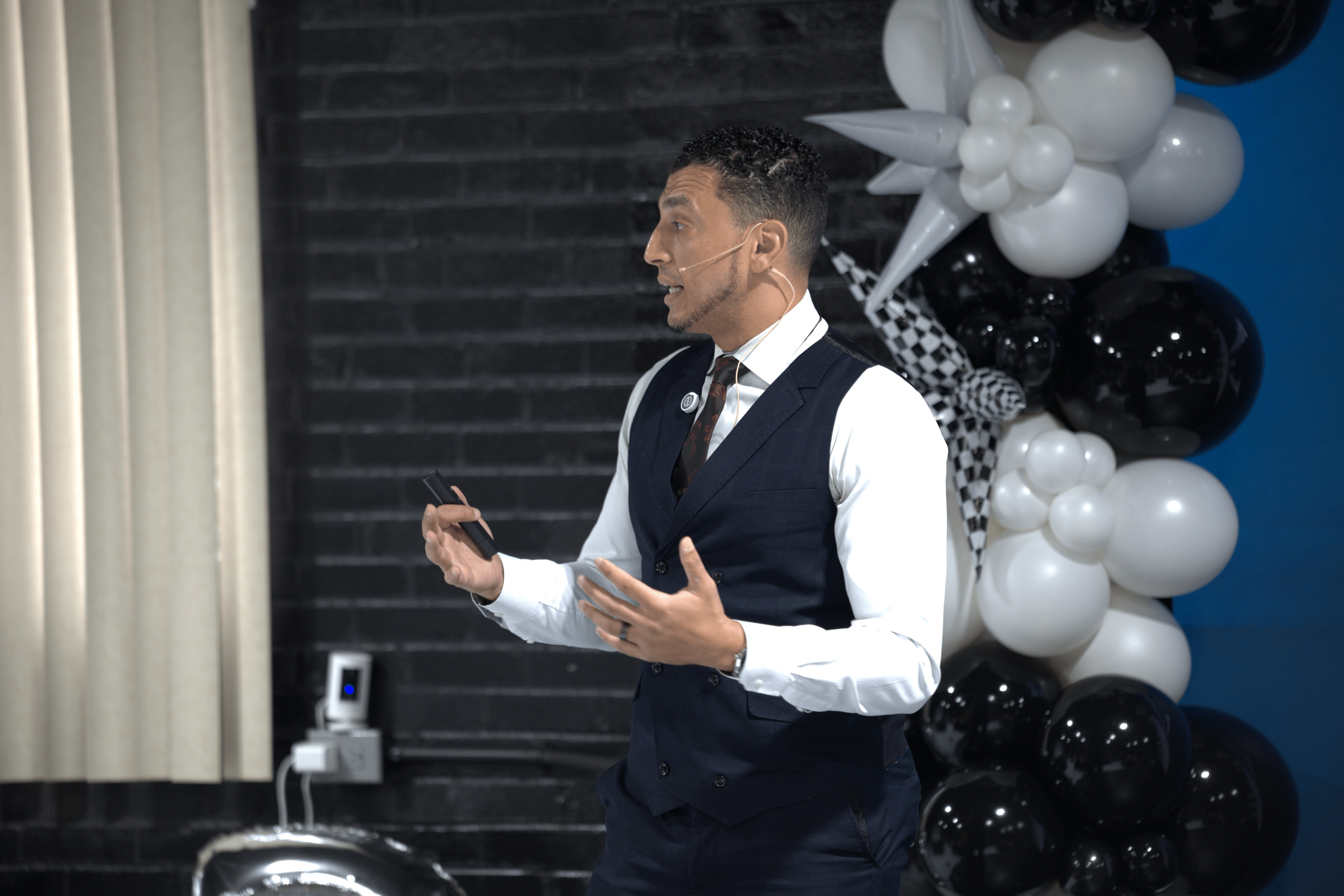 Ibrahim Awad presenting, mic in hand
