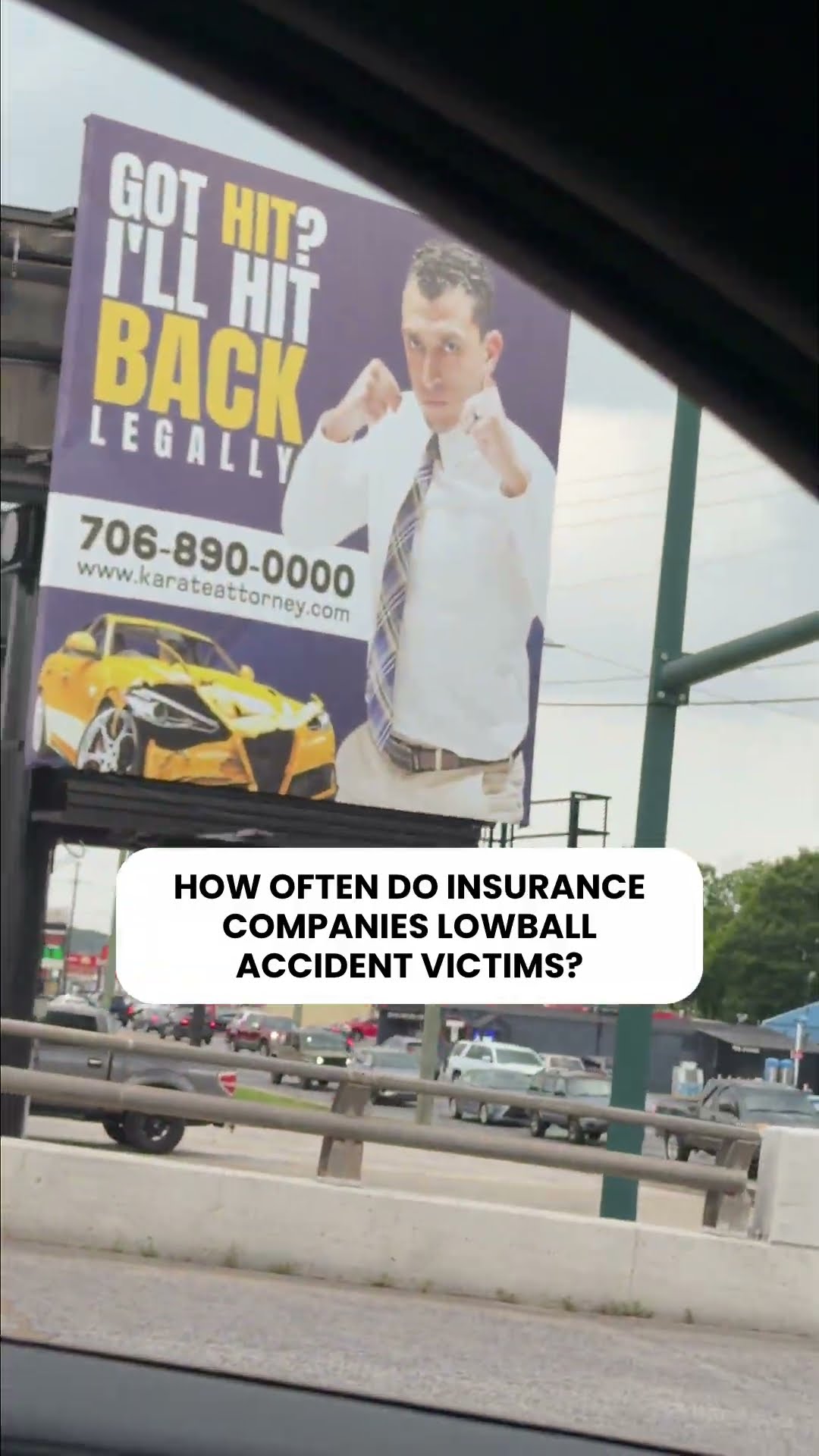 The "Got hit? I'll hit back legally" billboard above a Georgia roadside, captioned "How often do insurance companies lowball accident victims?"